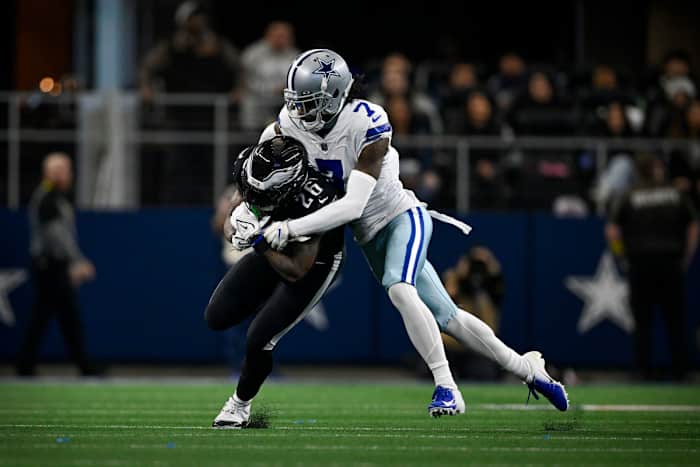 Dallas Cowboys cornerback Trevon Diggs tackles Philadelphia Eagles running back Miles Sanders